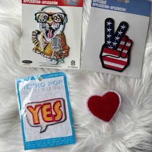 A lot of four appliqué patches. Heart, peace sign, timer, and yes!